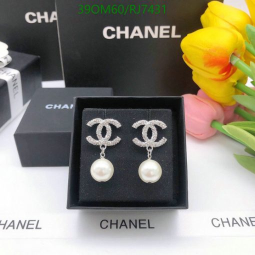 Designer logo earrings with pearls on display.