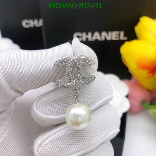 Elegant pearl pendant with sparkling design on white glove.