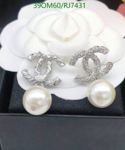 Pearl earrings with silver embellishment on white flower.