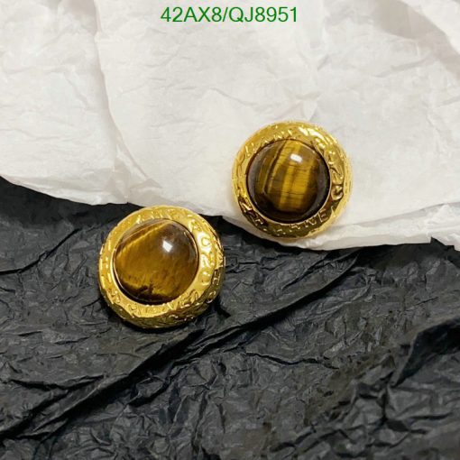 Gold tiger's eye gemstone earrings on contrasting paper.