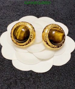 Gold tiger's eye cufflinks on fabric.