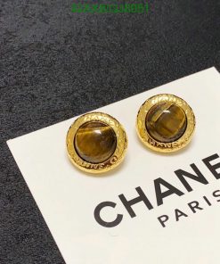 Gold-tone earrings on branded card.