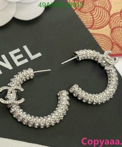 Diamond-encrusted Chanel logo earrings on display.