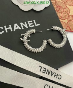 Chanel logo earrings with rhinestones on branded packaging.