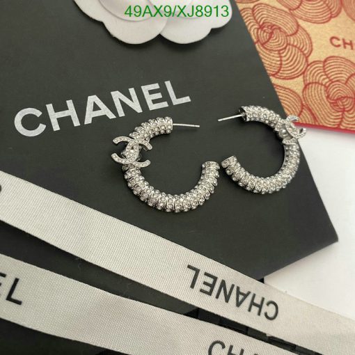 Chanel logo earrings with rhinestones on branded packaging.