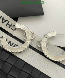 Silver designer hoop earrings on branded background.