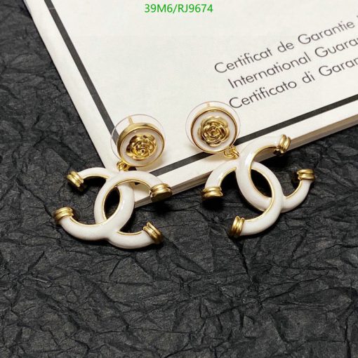 Designer gold and white earrings on certificate background.