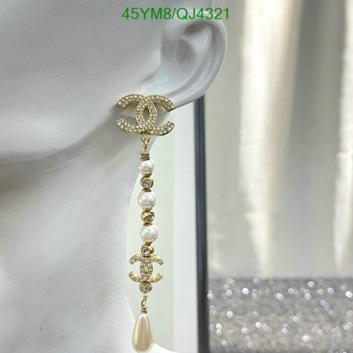 Luxury pearl dangle earring displayed on mannequin.