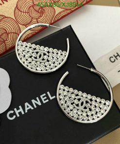 Silver designer logo hoop earrings on branded packaging.