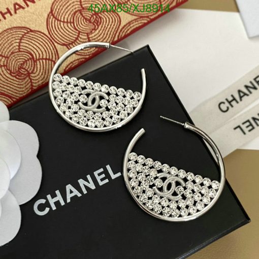 Silver designer logo hoop earrings on branded packaging.