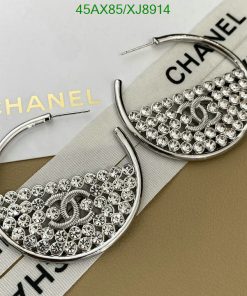 Designer crystal-embellished hoop earrings on branded background.