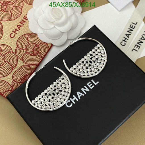 Chanel branded silver rhinestone hoop earrings on display.