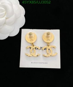 Gold designer logo earrings on white display