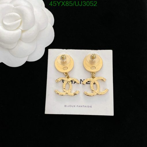 Gold designer logo earrings on white display