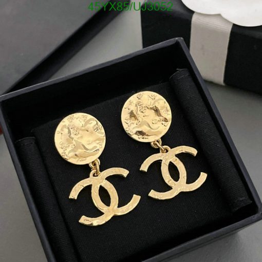 Gold designer logo earrings in box.