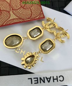 Designer gold-tone earrings with gemstones and logo.