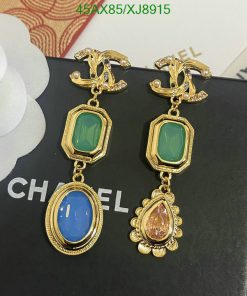 Elegant gemstone earrings on branded display.