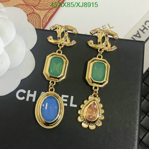 Elegant gemstone earrings on branded display.