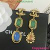 Vintage-inspired gold earrings with colored gemstones.