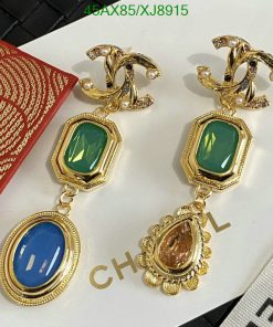 Elegant designer earrings with green and blue stones.