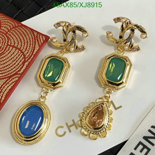 Elegant designer earrings with green and blue stones.