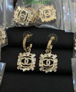 Gold designer earrings with jewels on display.