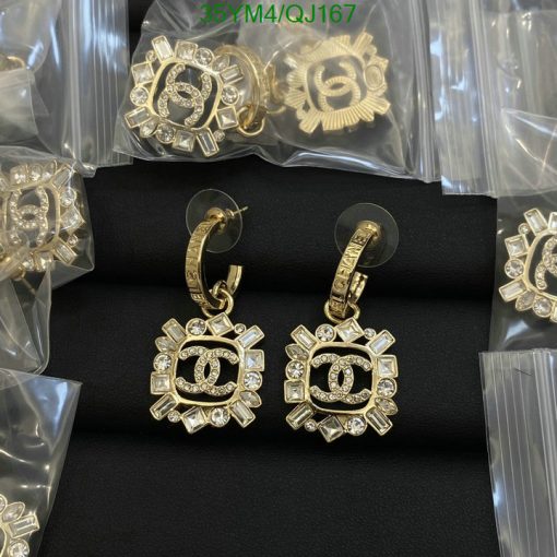 Gold designer earrings with jewels on display.