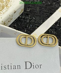 Gold Dior logo earrings on white branded box.