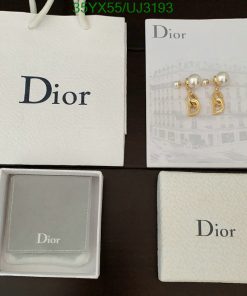 Dior jewelry packaging and earrings on display.