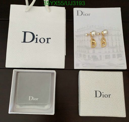 Dior jewelry packaging and earrings on display.