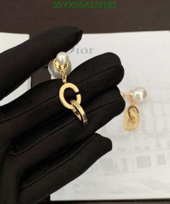 Gold designer logo earrings with pearl detail.