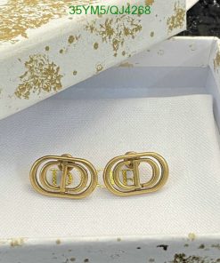 Gold designer logo earrings in decorative box.