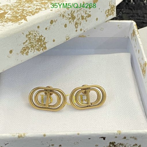 Gold designer logo earrings in decorative box.