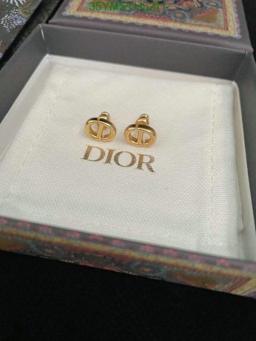 Gold designer logo earrings in branded box.