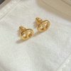 Gold designer cufflinks on white fabric.