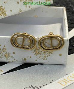 Gold designer logo earrings in white branded box.