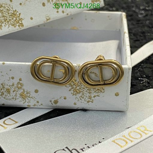 Gold designer logo earrings in white branded box.