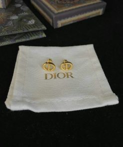 Designer earrings on branded cloth with boxes.