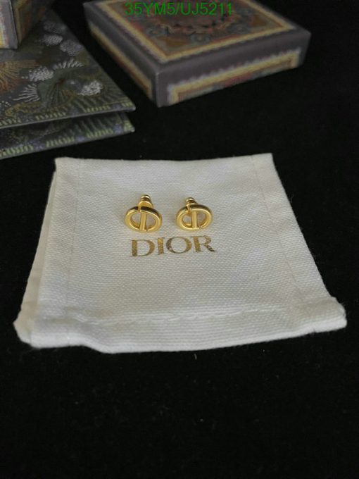 Designer earrings on branded cloth with boxes.