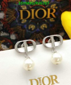 Dior logo pearl drop earrings on display.