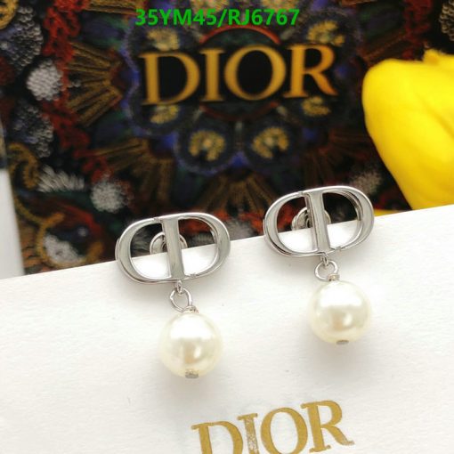 Dior logo pearl drop earrings on display.