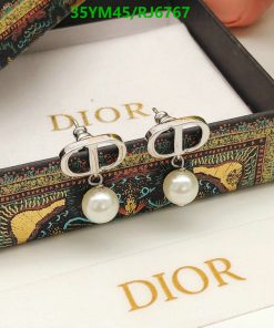 Designer pearl earrings on patterned display box