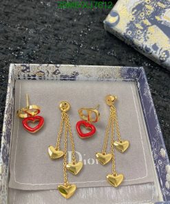 Heart-shaped gold earrings on display box.