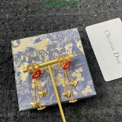 Dior key-shaped earrings with heart pendants on patterned box.