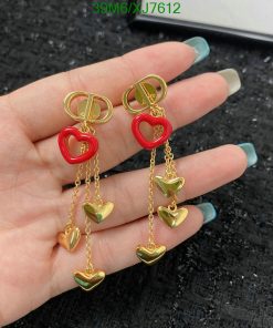 Gold heart dangle earrings with red accents.