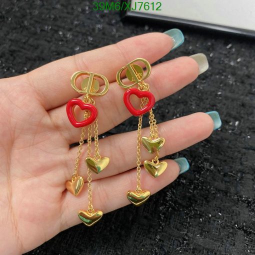 Gold heart dangle earrings with red accents.