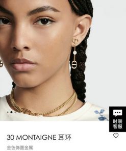 Woman modeling Dior earring and necklace.