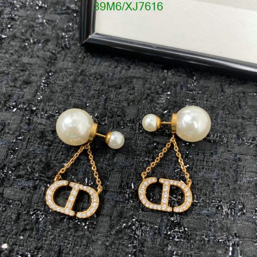 Pearl earrings with gold logo and chain detail.