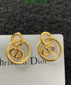 Gold designer logo earrings on branded card.