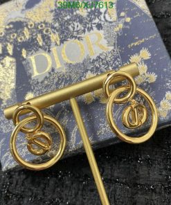 Gold Dior earrings on branded box